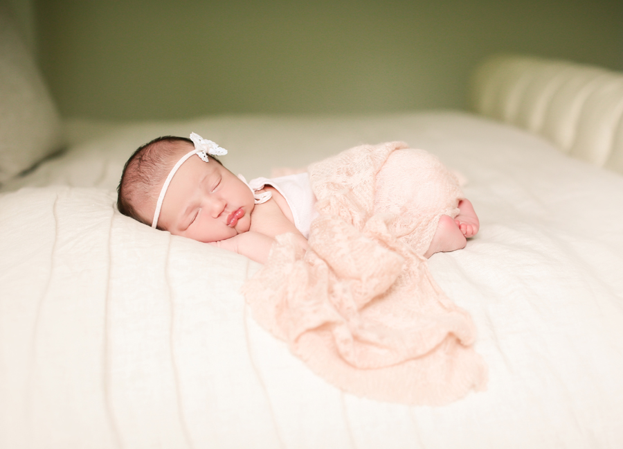 Baby girl sleeping on the bed at an in-home newborn session in Chandler, Arizona