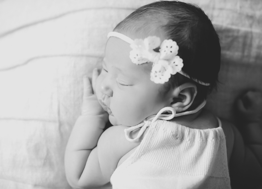 Black and white image of a newborn baby at an in-home newborn session in Chandler, Arizona