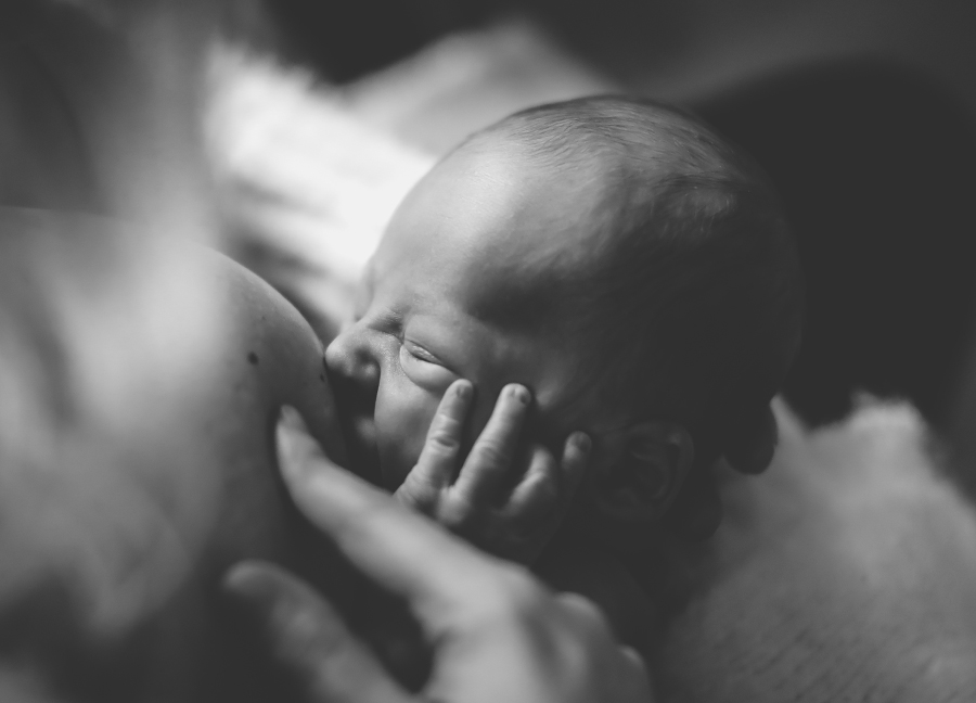 Closeup photo of baby breastfeeding.