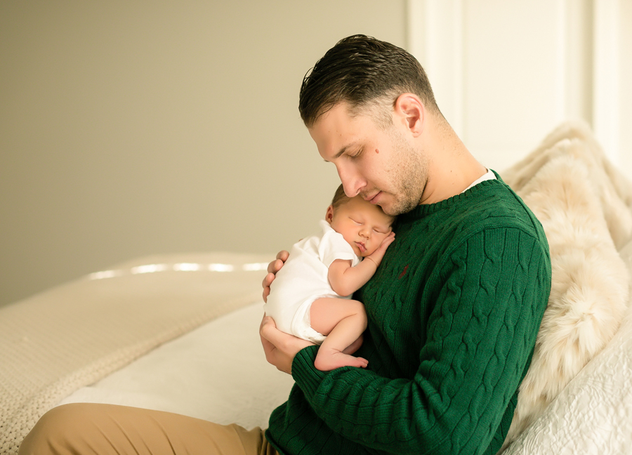 A father cuddling with his baby boy at an in-home newborn session in Scottsdale, Arizona