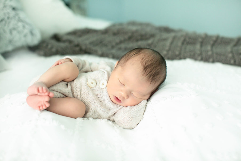 A baby boy sleeping on his side during an in home newborn photography session Northern Virginia newborn photographer, Stephanie Honikel Photography.