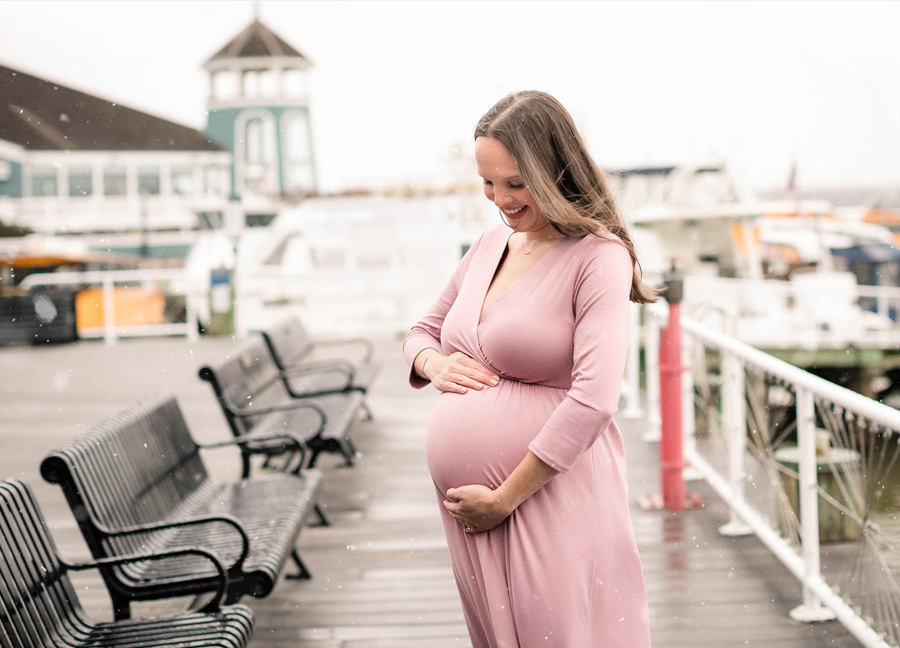 A pregnant woman in Old Town Alexandria during a maternity photo shoot in Northern Virginia.