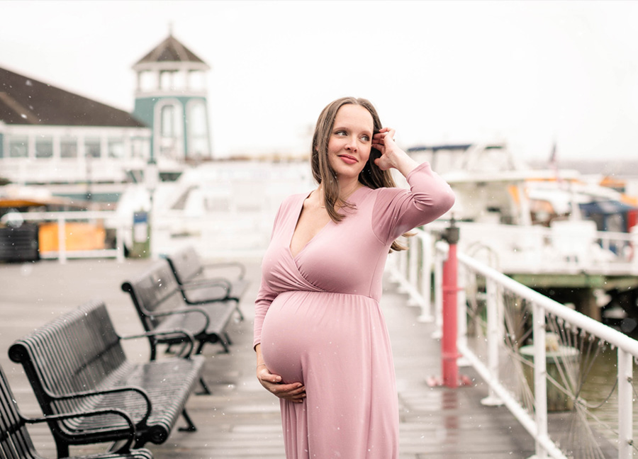 A pregnant woman during a winter maternity photo shoot with top Northern Virginia newborn photographer, Stephanie Honikel Photography.