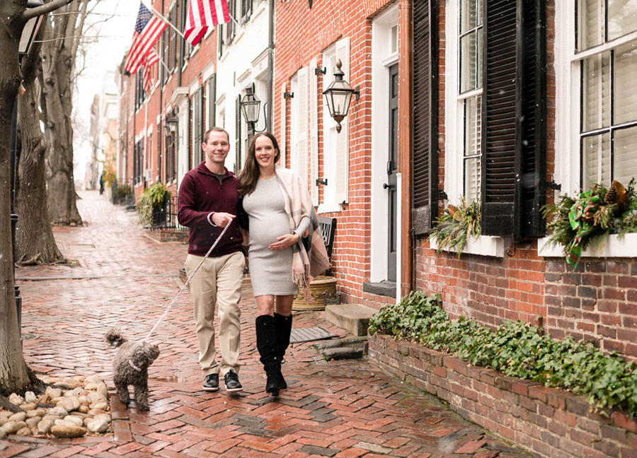 A couple walking down the streets of Old Town Alexandria during Old Town Alexandria Maternity Photoshoot with Northern Virginia newborn photographer, Stephanie Honikel Photography.