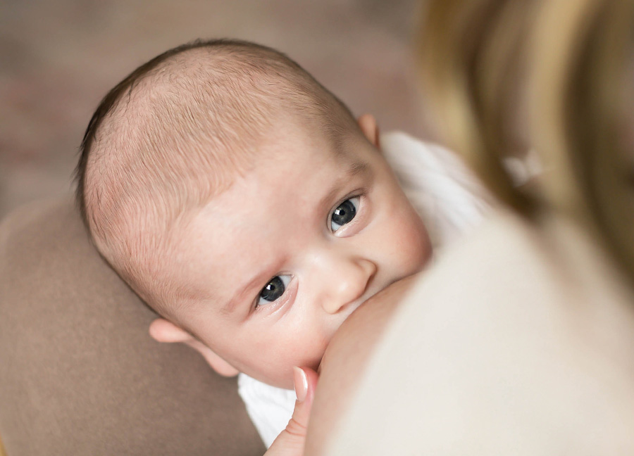 A baby breastfeeding at a Northern Virginia newborn photography session with Stephanie Honikel Photography.
