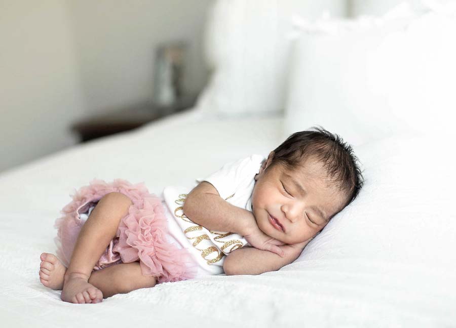 A sweet baby girl sleeping on her side during a D.C. newborn photography session.