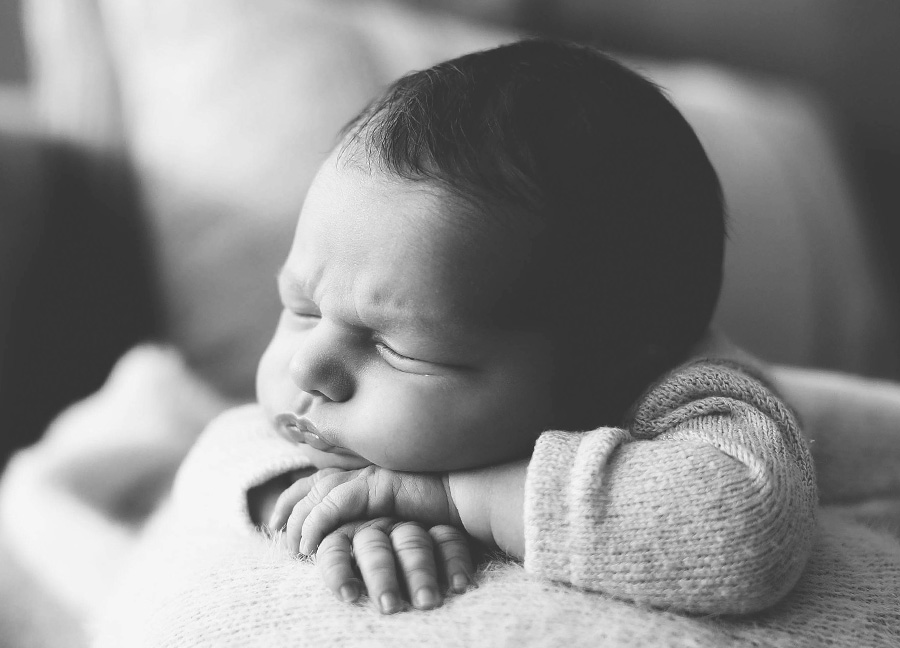 newborn resting their head on their hands captured by a newborn photographer in Northern Virginia