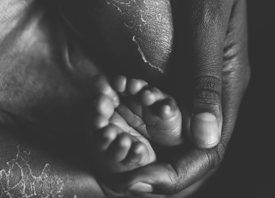 Black and white images of baby feet in moms hands captured by Northern Virginia newborn photographer, Stephanie Honikel Photography. 