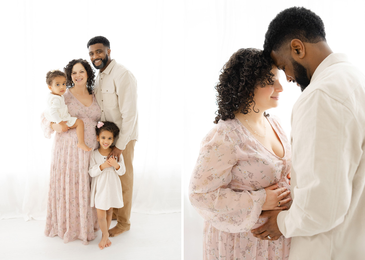 A family with two small children standing in front of the window during their simple studio maternity session 