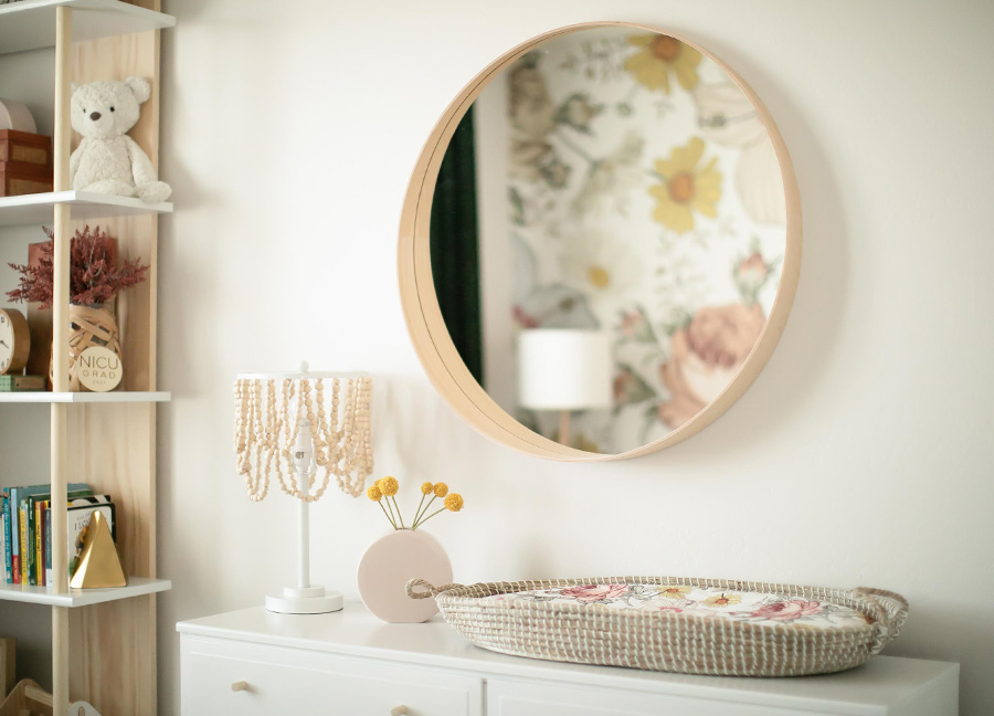 mirror and changing table of a babys nursery