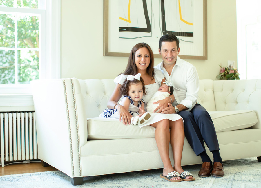 Washington D.C. Newborn Photographer captures a family of four sitting on the couch