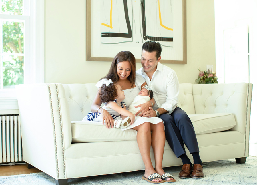 Washington D.C. newborn photographer captures a family of four sitting on a couch