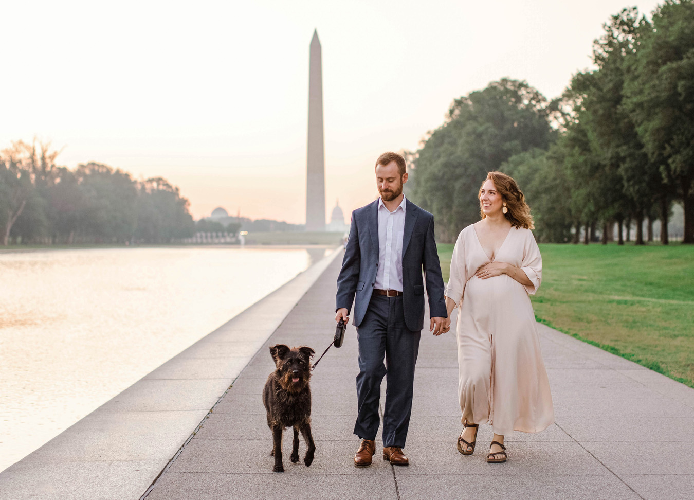 Husband and wife with their dog at the National Mall in D.C. for their maternity session with Stephanie Honikel Photography 