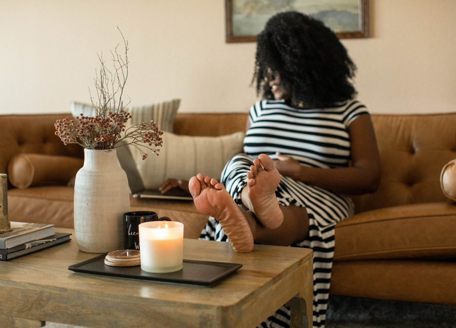 pregnant mom resting with her feet up to combat morning sickness