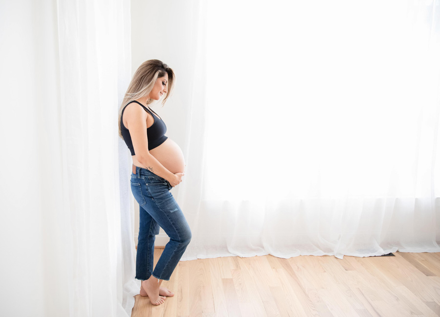 pregnant mom holding her belly: C-Section Care Tips