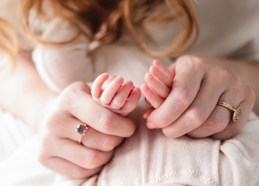 tiny hands held by moms hands