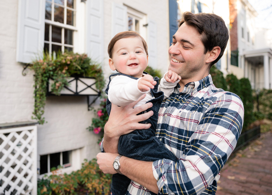Father and son smiling on P Street NW during a family photo shoot in Washington, D.C.