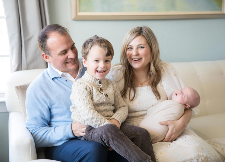 family of four photographed during a cozy D.C. Christmas newborn session at home