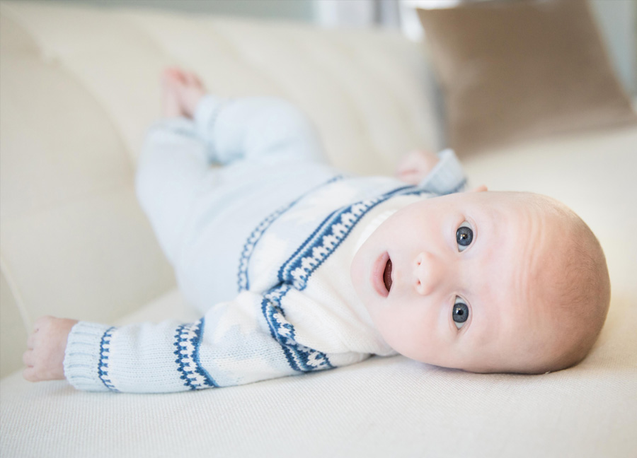 Baby boy looking into the camera during a DC in home newborn photography session.