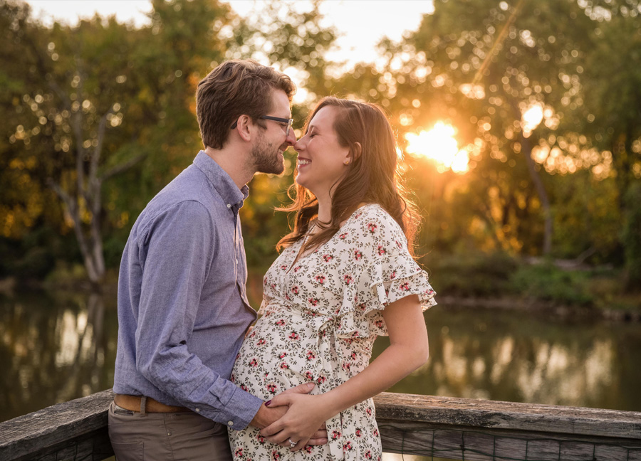 A couple posing at Kingman Island during their maternity photo session in Washington, D.C.