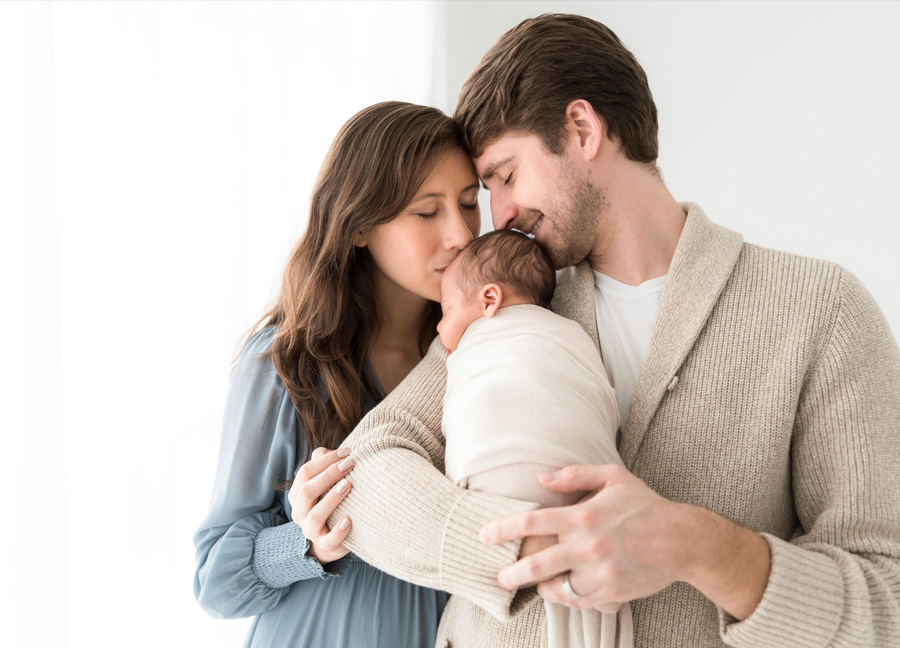 Parents and their newborn baby during a studio newborn photography session in Northern Virginia. 