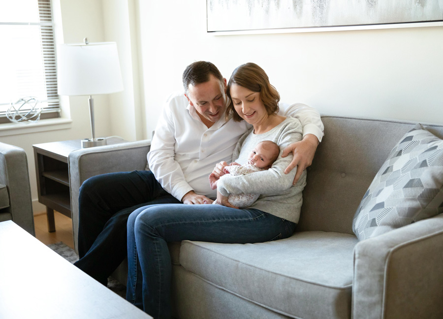 A family of three sitting on a sofa during a photo shoot in Washington, D.C.