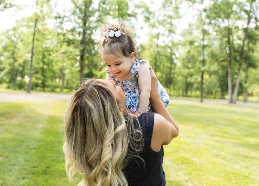 mom and daughter outside looking at each other taken by a northern virginia newborn photographer