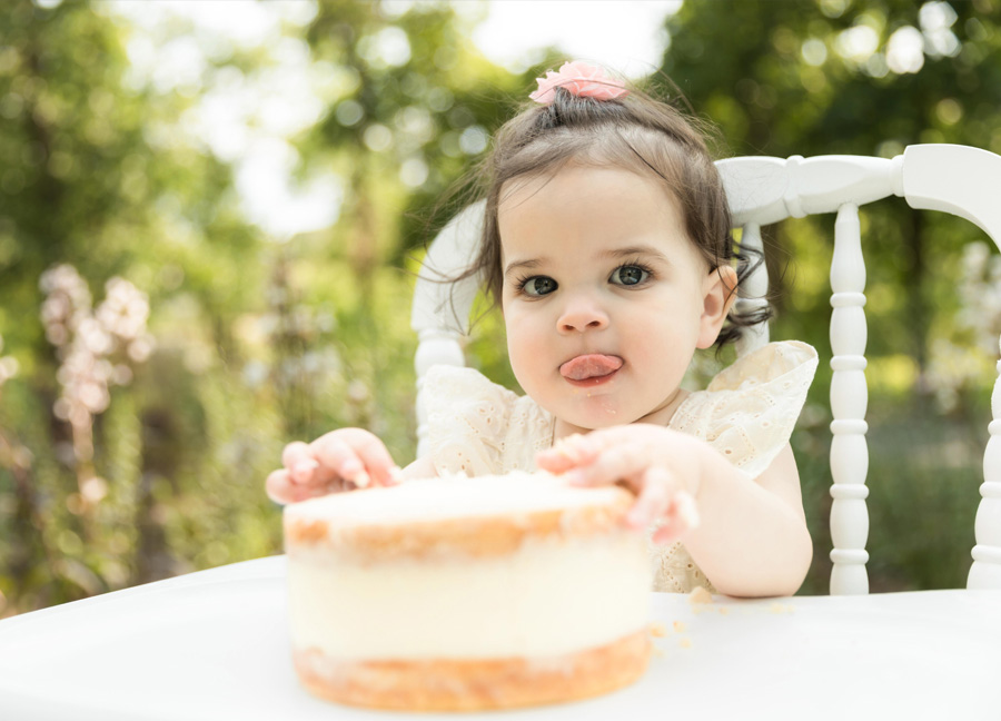 northern virginia newborn photographer captures a little girl eating her cake on her first birthday