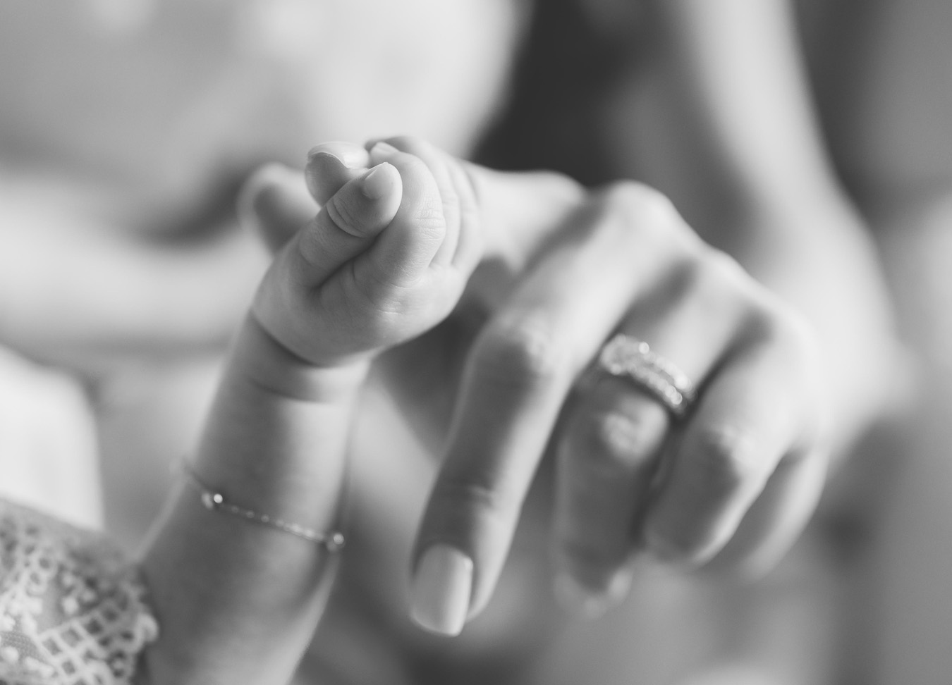 DC family photographer, black and white image of a baby girl's hand wrapped around her mother's finger