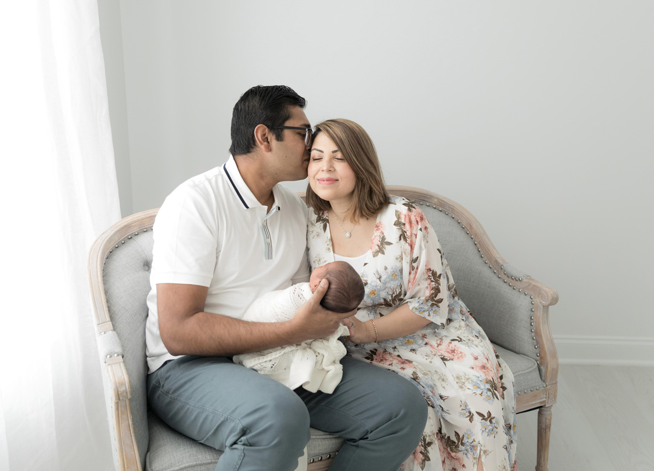 D.C. Baby Stores featuring a man kissing a women on the cheek while holding a newborn baby