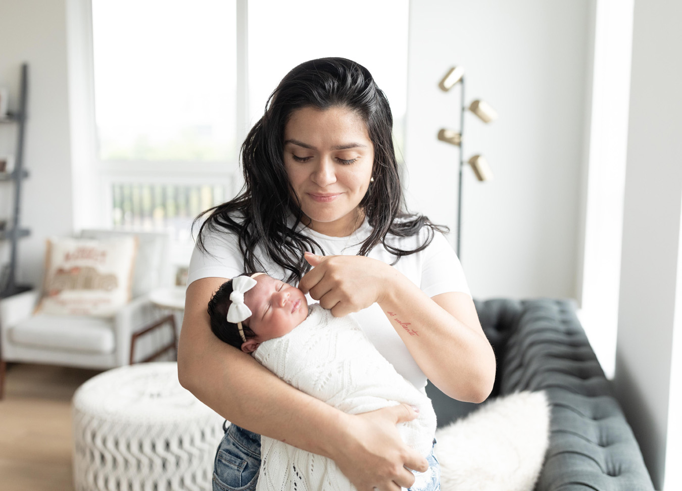 mom holding newborn baby photographed by a newborn photographer in D.C.