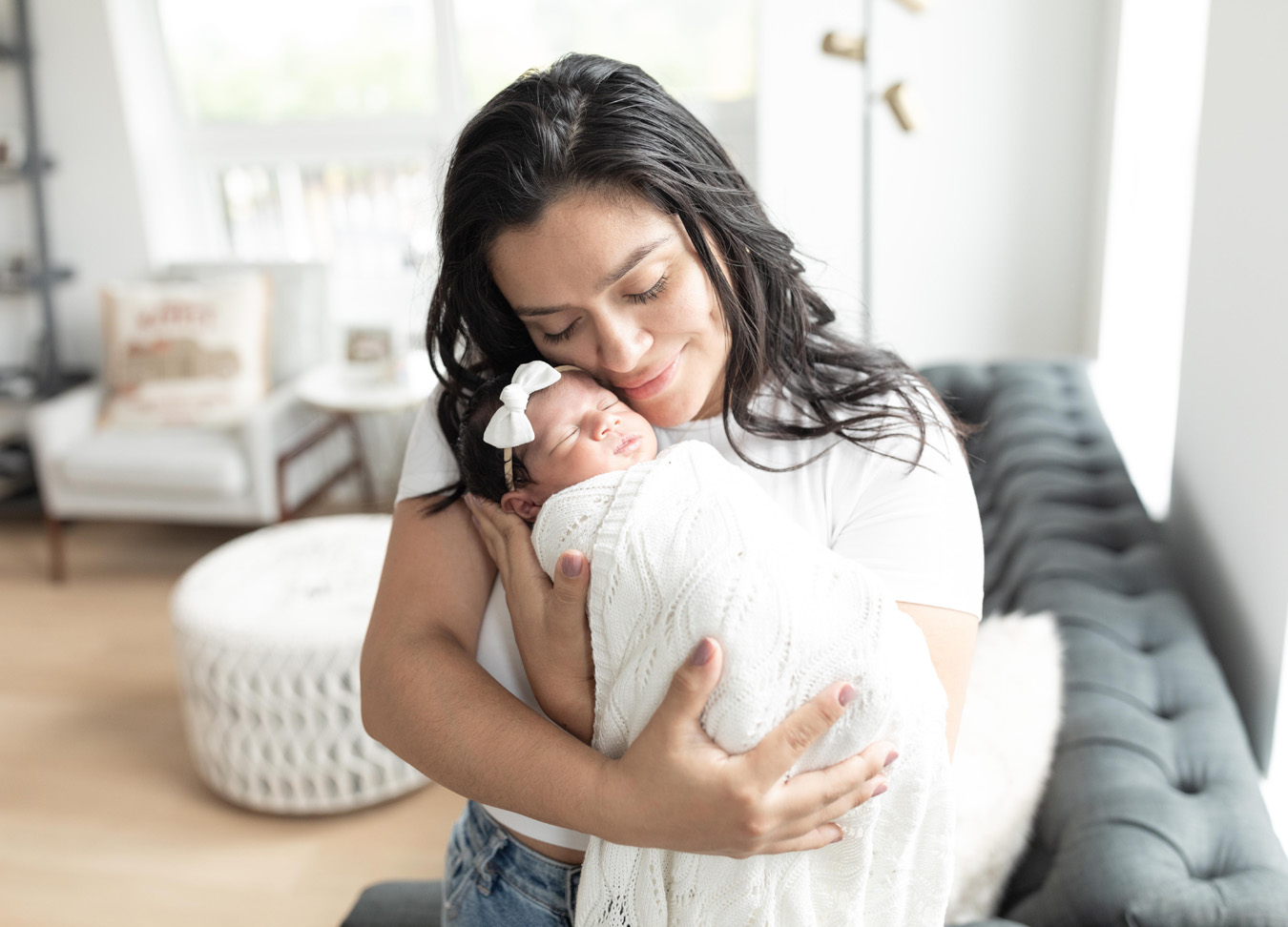a loving embrace between a mom and her newborn baby photographed by a newborn photographer in D.C.