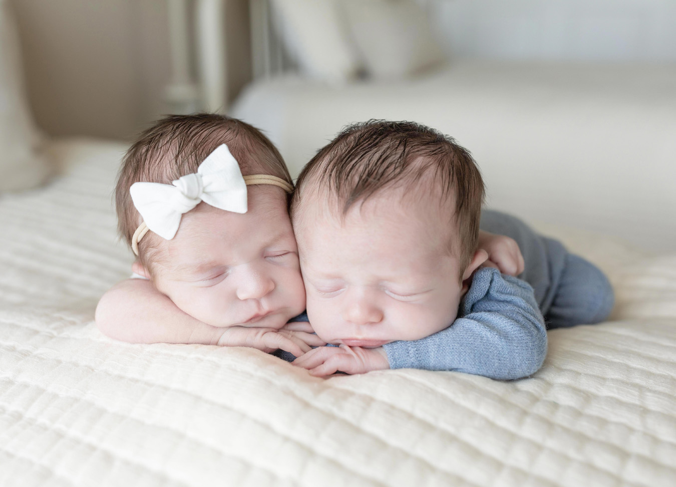 twin newborn session with both twins laying on their arms