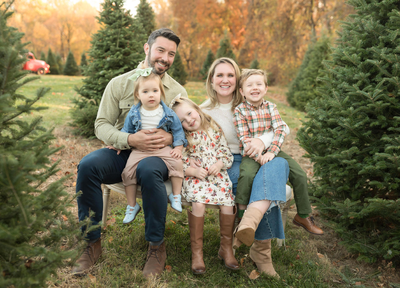 best Northern Virginia Christmas activities in 2023 featuring a family of five sitting in a tree field.