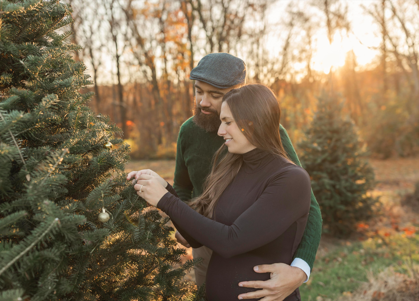 Pregnant mom and dad looking at a tree together