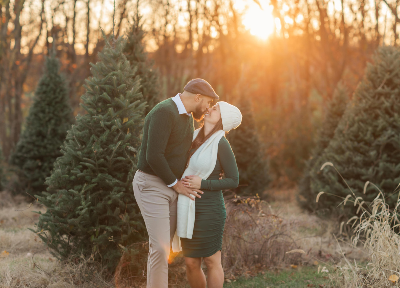 a cozy picture is captured of a pregnant woman and her husband at a tree farm in Northern Virginia