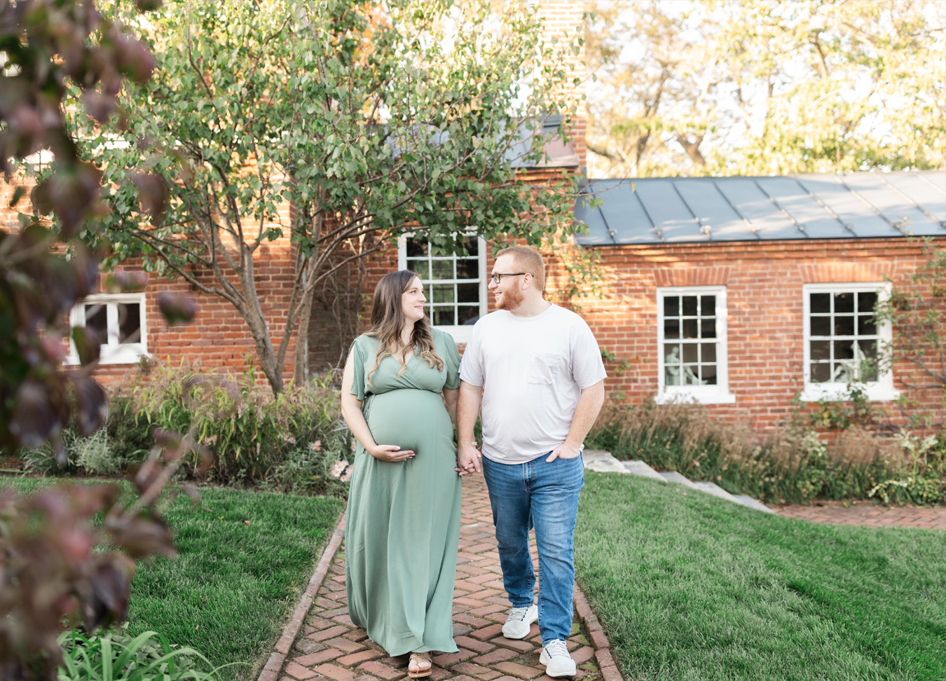 pregnant mom and dad walking down a path together captured by a D.C. maternity photographer