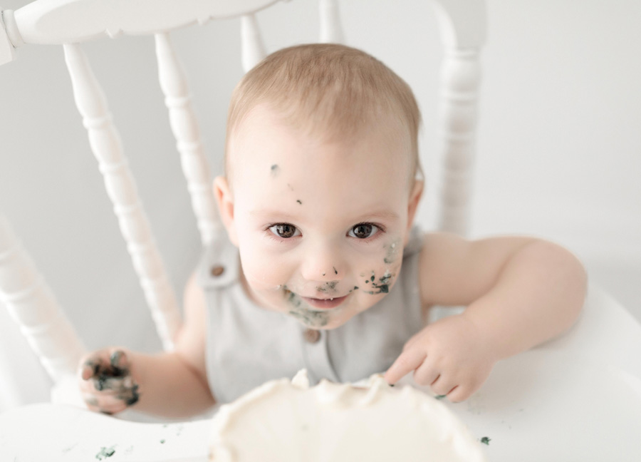 smiling baby boy during a cake smash session