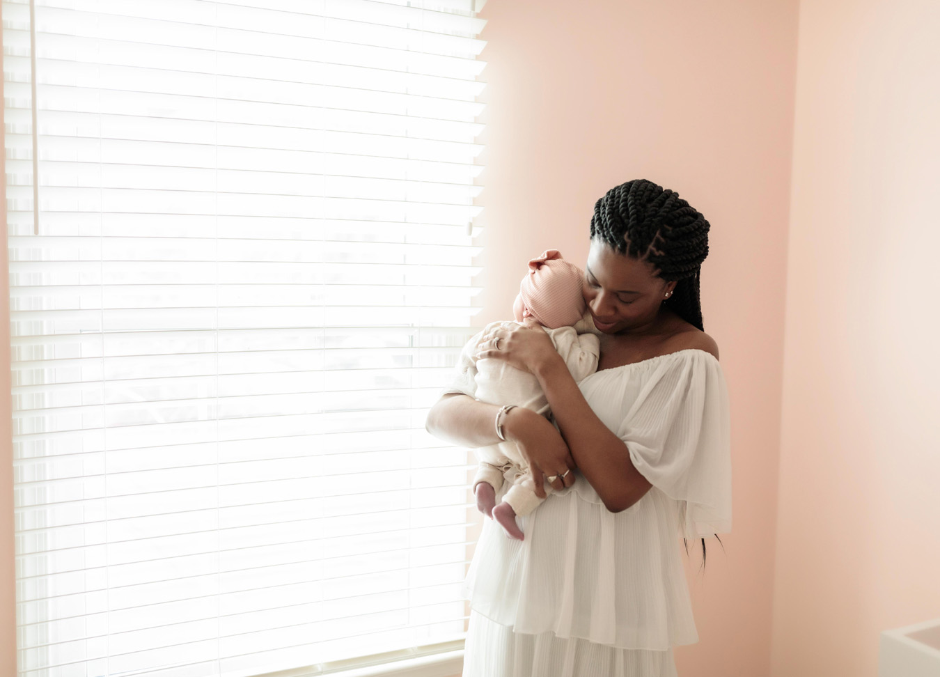 newborn photographer captures a mom holding her newborn baby girl
