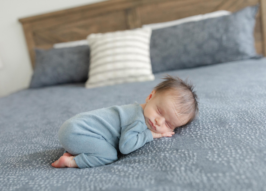 newborn baby laying on the bed