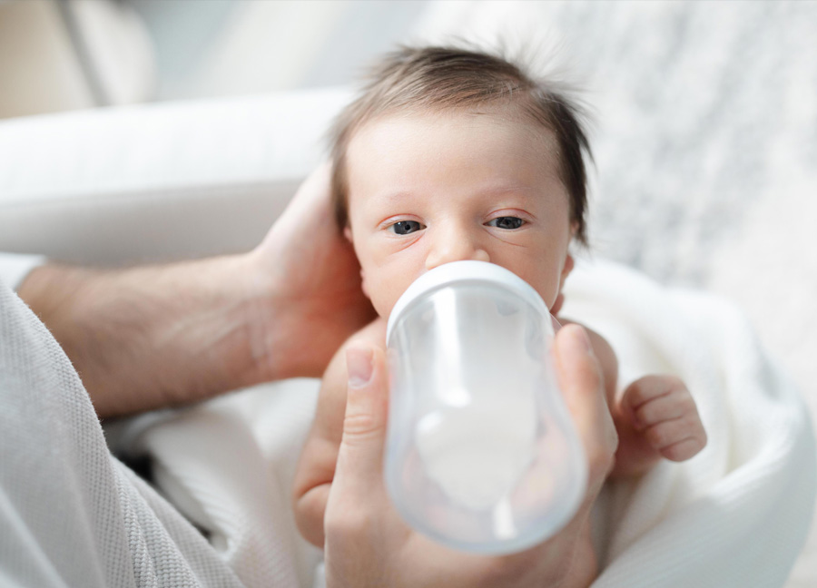Washington D.C. newborn photographer features a little boy drinking a bottle
