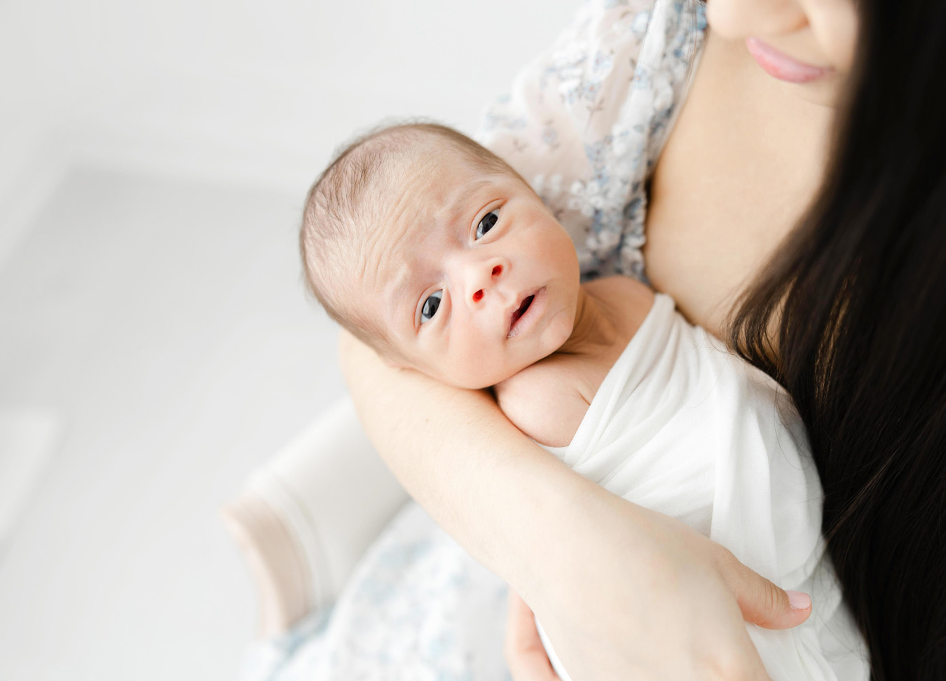 newborn baby being held by his mother captured by a Northern Virginia newborn photographer