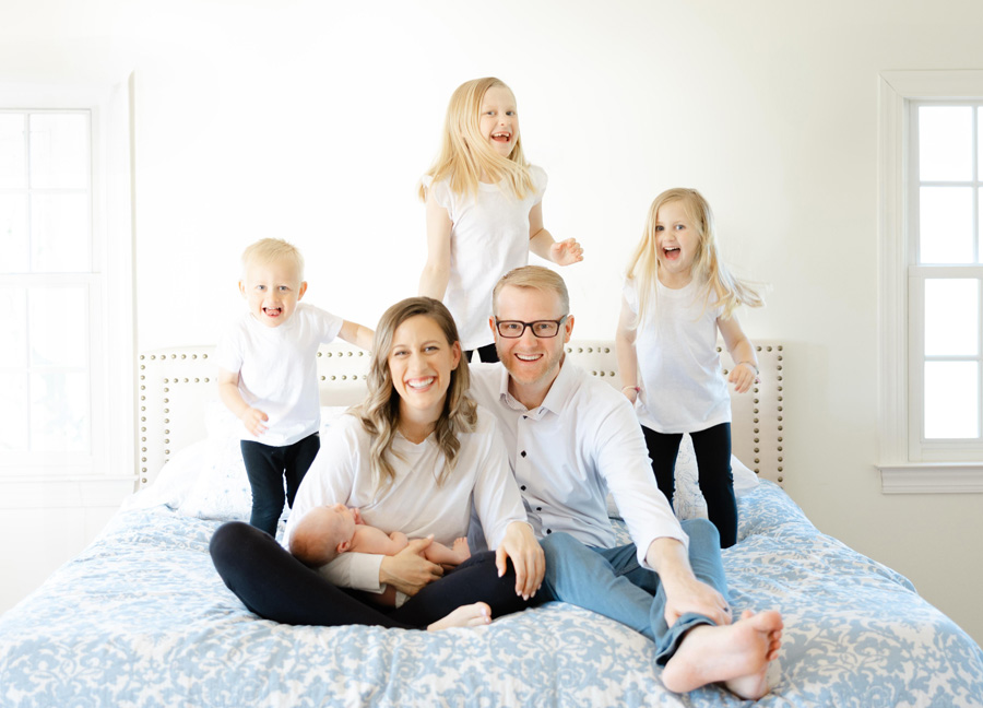 family smiling and laughing together captured by a newborn photographer in Northern Virginia