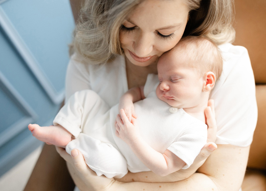 mom snuggling her newborn baby captured by a newborn photographer in D.C.