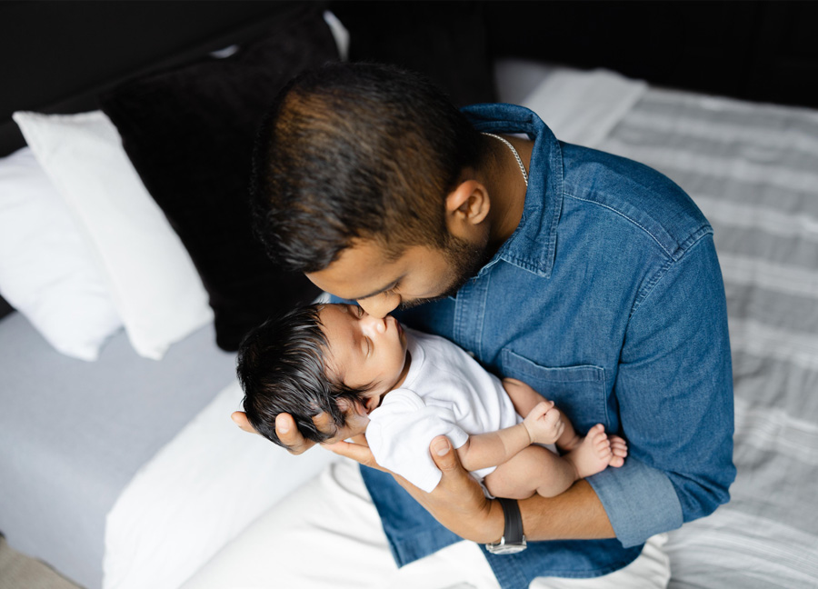 dad and newborn baby snuggling captured by a newborn photographer in Northern Virginia