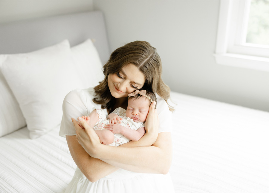 snuggles between a mother and her newborn baby girl - captured by a Washington DC newborn photographer