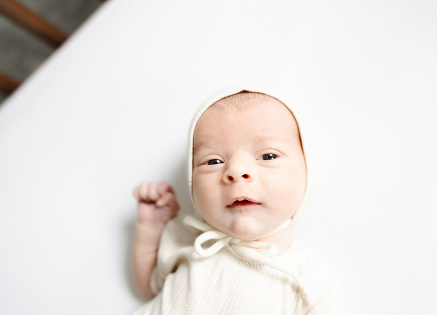 newborn baby looking at the camera