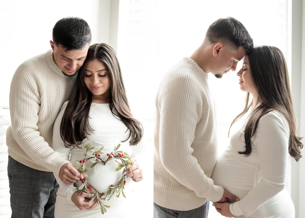 a man and woman posing for maternity photos in their living room window