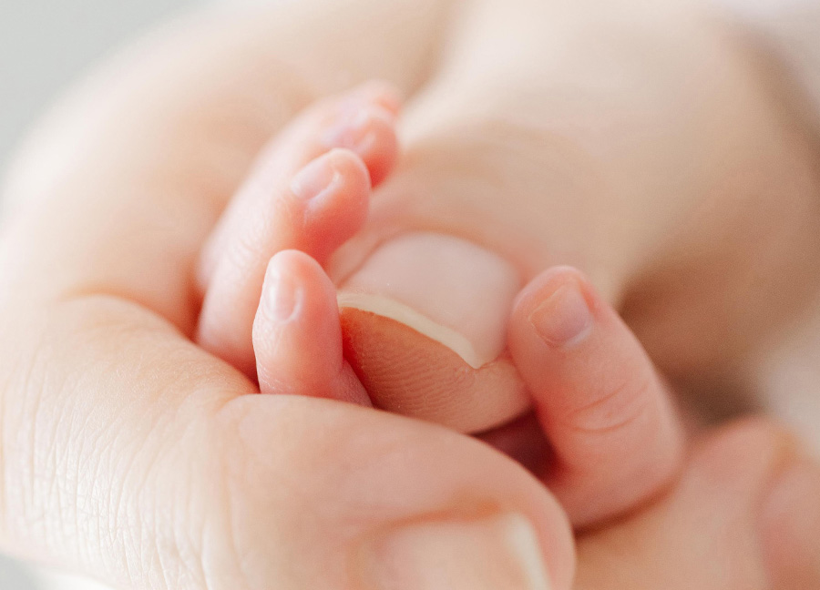 capturing tiny fingers in an adult hand captured by a newborn photographer in northern virginia