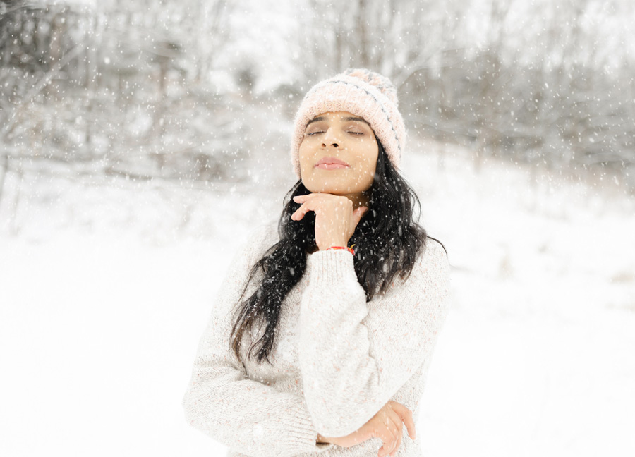 pregnant woman pondering in the snow captured by a maternity photographer in DC/Northern Virginia